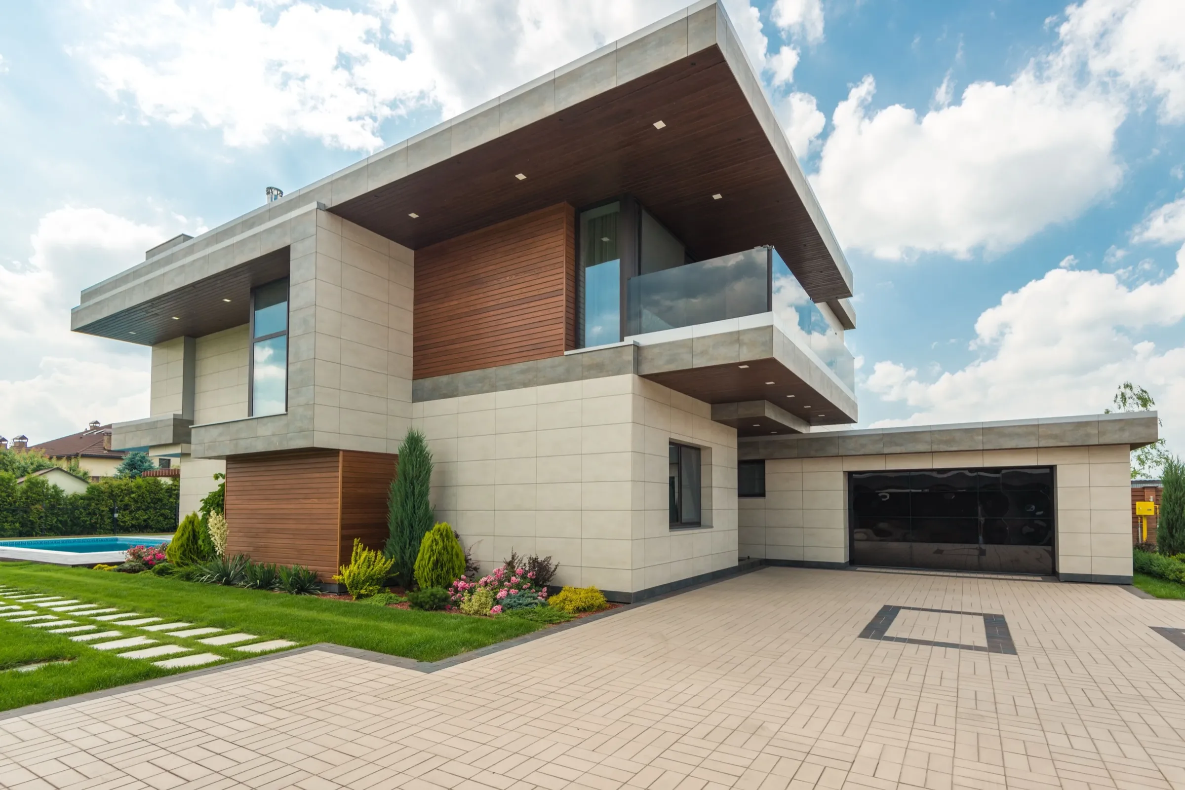 Modern house with an angled cantilevered roof and paved driveway